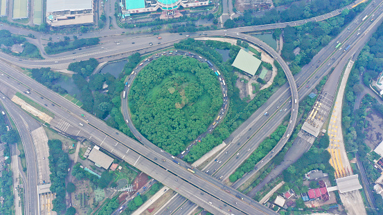Aerial top down view on massive multi-level interchange on Jakarta city on a sunny summer day with light traffic.