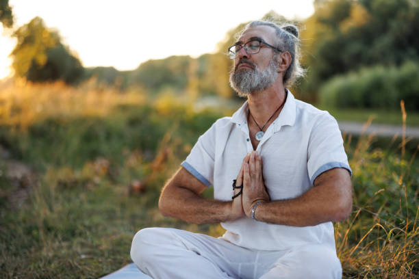 istock Mature man meditating in nature 1425780251