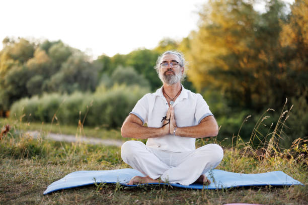 istock Mature man meditating in nature 1425780327