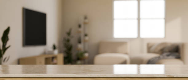 istock Empty tabletop in front of blurred minimal and cozy living room in background. 1425781617