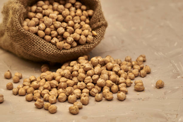 istock chickpeas in a canvas bag and scattered on the table 1425782154