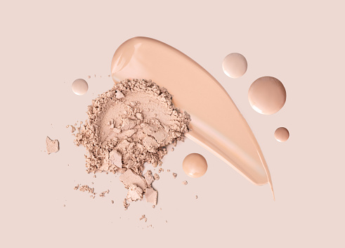High angle view of a face powder and makeup brush against a white background