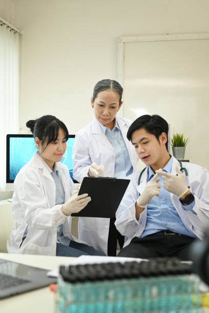 istock Professional scientists wearing white coats conducting experiment in research laboratory. Scientific research and technology concept. 1425785083