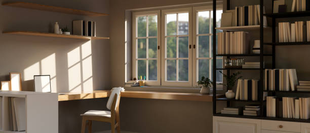 istock Minimal and comfortable home workspace near the window with wood corner working table 1425785772