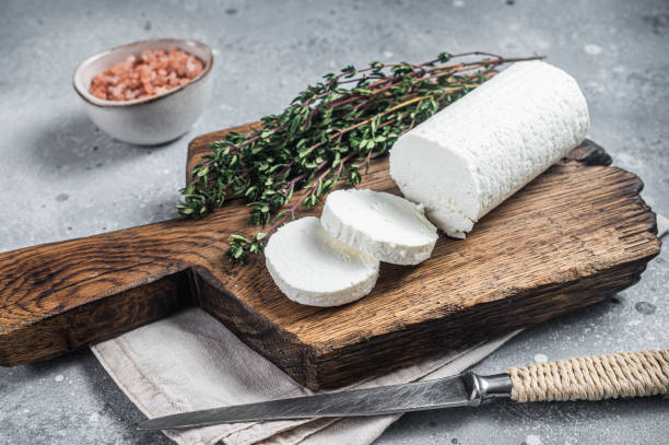 istock Fresh goat soft cheese with thyme. Gray background. Top view 1425788353