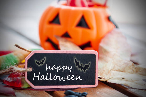 istock label with happy halloween text and pumpkin background with sweets 1425789021
