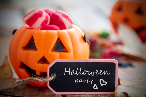 istock label with happy halloween text and pumpkin background with sweets 1425789165