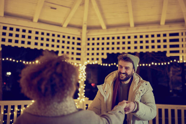 istock Happy man enjoying with his girlfriend during romantic night on Christmas. 1425789624