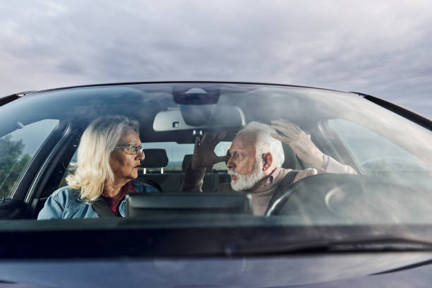istock Frustrated senior couple arguing during trip by a car. 1425791603