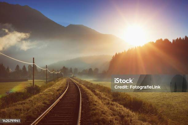 Railway And Train In The Alpes At Sunrise Stock Photo - Download Image Now - Train - Vehicle, Austria, Nature