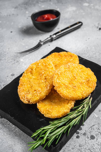 istock Hash brown potato with ketchup, hashbrown on white table. Gray background. Top view 1425792521