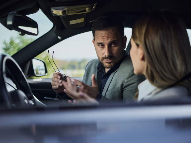 istock Business couple having a discussion in a car. 1425793236