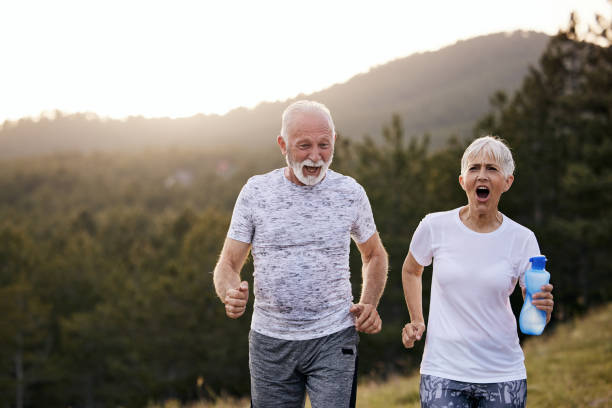 istock Happy senior couple jogging in nature. 1425795079