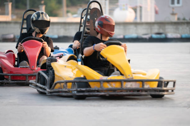istock Group of teens riding go carts 1425800010