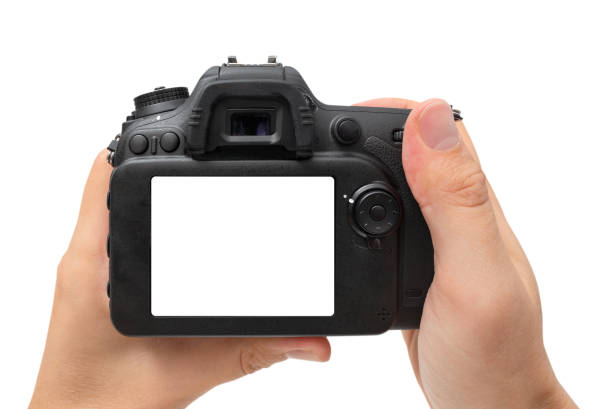 istock DSLR digital camera in hand isolated on white 1425800338