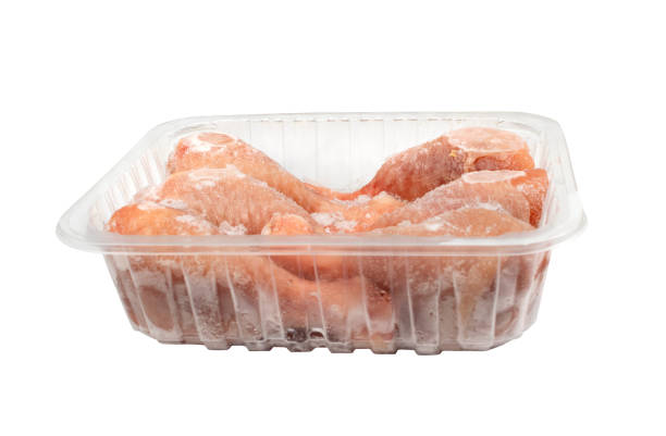 istock Raw Frozen Chicken Drumsticks in a Plastic Container Isolated 1425802164