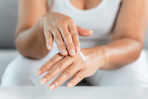 istock Woman applying body lotion moisturizer on her hands. 1425806251