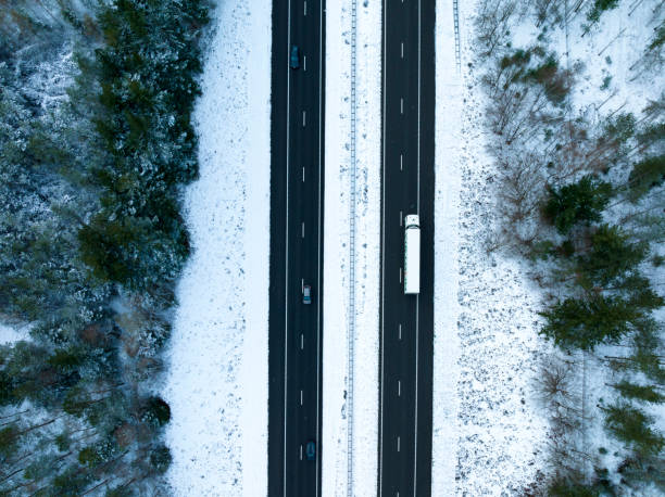 istock Highway through a snowy forest landscape seen from above 1425808638