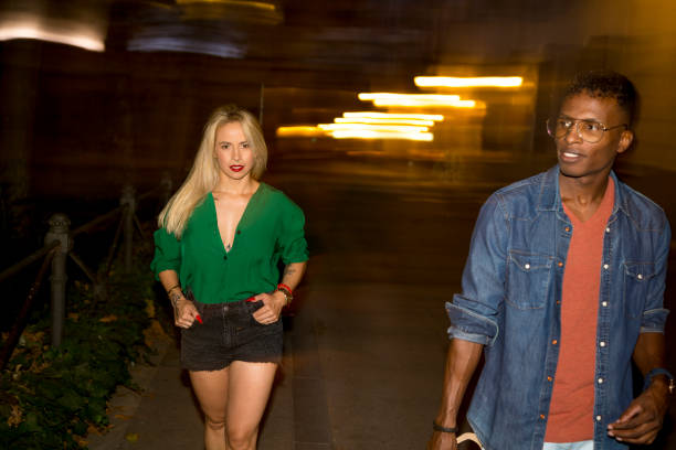 istock Multiethnic people walking in the street at night 1425809121