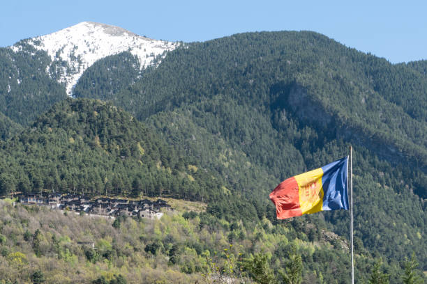 istock Flag of Andorra with mountains at background 1425809259