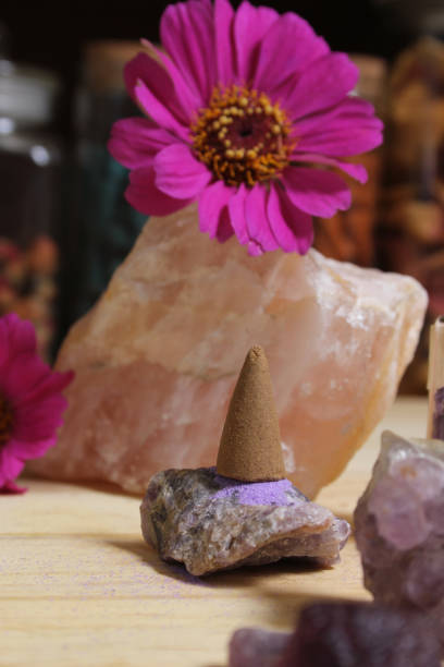 istock Amethyst Crystals With Flowers and Incense Cones on Meditation Table 1425820079