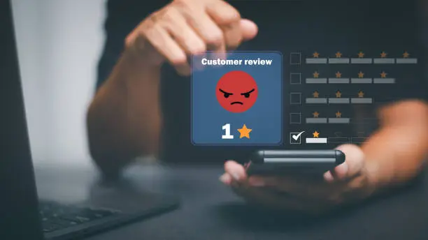 Photo of Male consumers express dissatisfaction after receiving a product or service. Negative rating ideas from a business or product. Online ratings, performance data, and evaluation of genuine user reviews.