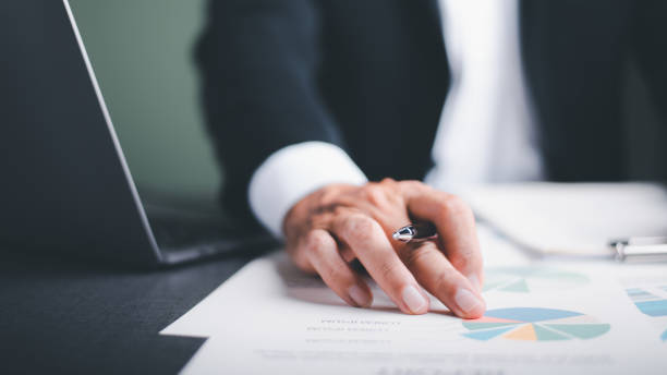 istock Businessmen analyze market reports with statistics from charts and graphs, managing business and financial strategies, professional analysts view investment information, consulting and presentations. 1425825829