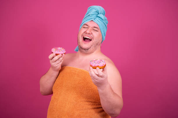 istock Funny fat man is washing himself in the shower. 1425826523