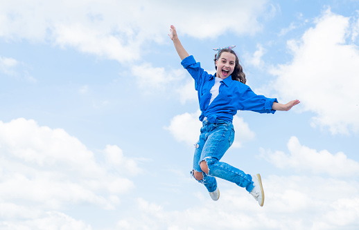 cheerful teen girl jumping high. kid jump outdoor. kid fashion and beauty. sense of freedom. portrait of energetic child girl. concept of future. happy childhood. Feeling free and happy.