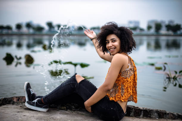 Young woman in an orange hippie crop top stock photo