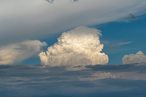 Cumulonimbus towers in the distance, arriving to the high were they could produce hail.