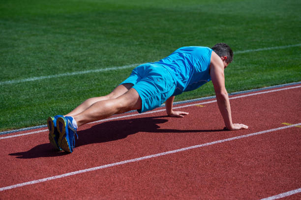 istock muscular man stand in plank making push up on sport training, stamina 1425837801