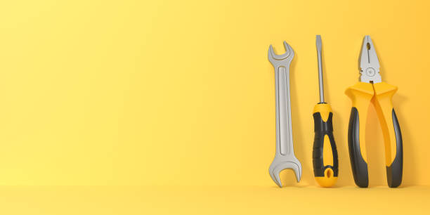 istock Wrench, screwdriver and pliers on a yellow background with copy space 1425837849