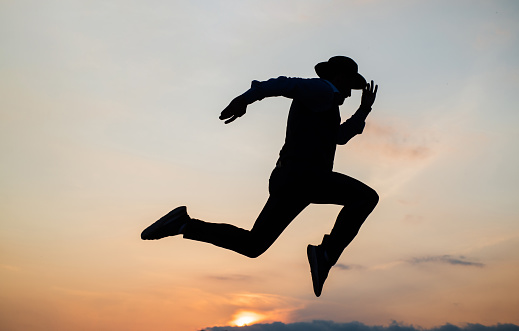 Do or Die. personal achievement goal. man silhouette jump on sky background. confident businessman running. daily motivation. enjoying life and nature. business success. freedom.