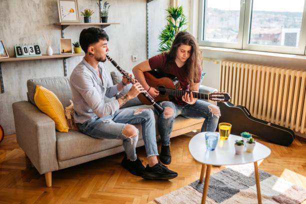 istock Two men playing clarinet and guitar at home 1425840716