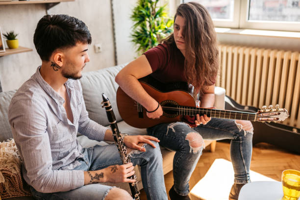 istock Two men playing clarinet and guitar at home 1425840762