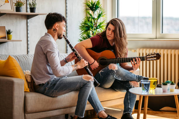 istock Two men playing clarinet and guitar at home 1425840822