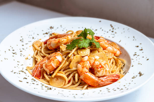 Shrimps Prawn Pasta Spaghetti served in a white plate stock photo