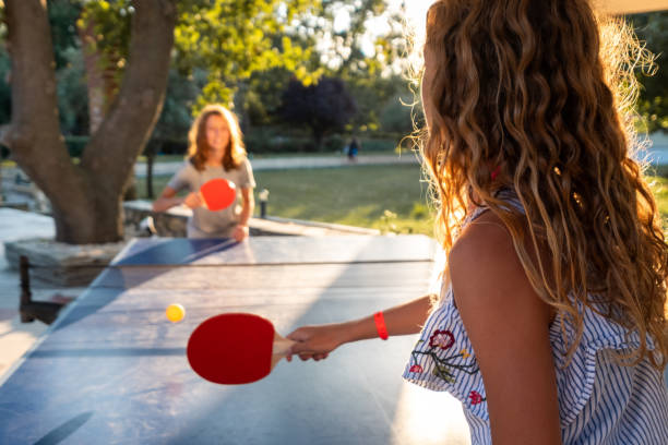 istock Girls playing table tennis on summer day 1425848698