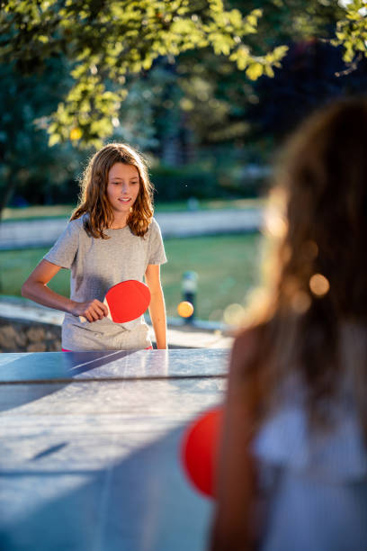 istock Girls playing table tennis on summer day 1425848976
