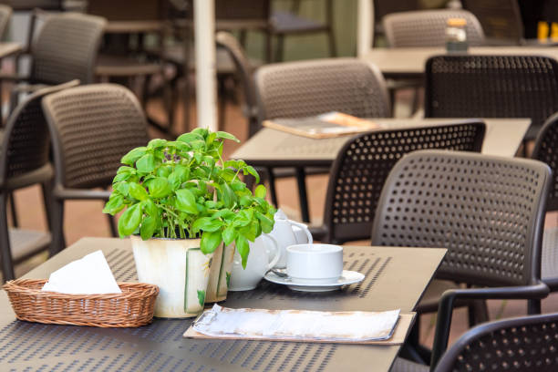 istock Empty table in outdoor cafe or restaurant. Tables and chairs at sidewalk cafe. Touristic setting, cafe table, sidewalk cafe furniture. 1425853041
