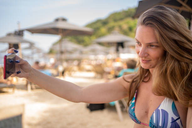istock Woman taking selfie while enjoying her time on beach holiday 1425853846