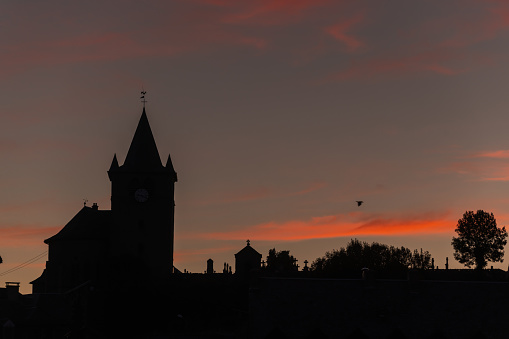 Silhouette of church of St Mathieu in Laguiole at sunset. Laguiole, Aubrac, cevennes, France.