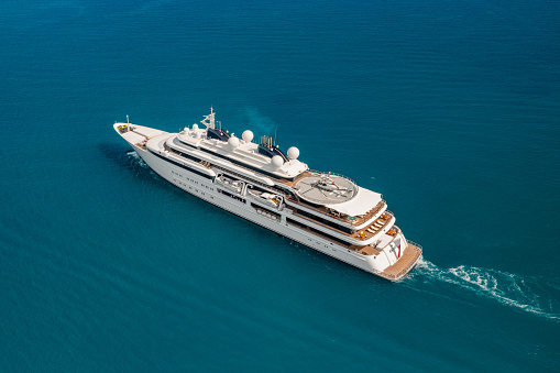 Aerial photo from a drone of the 124 meter super yacht Katara. Captured leaving Port Vauban, Antibes, Côte d'Azur, France.