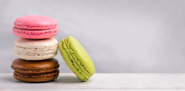 istock Pastel colorful macaroon cookies on vintage background 1425858446