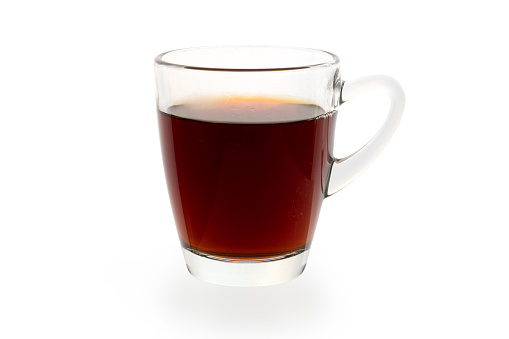 A glass cup of black tea, studio shot isolated against a white background. Photo contains a clipping path