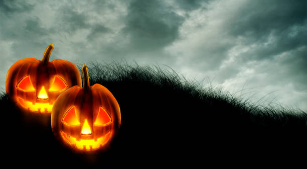 istock Halloween background wallpaper with jack o lantern scary pumpkins on dark sky. 1425861152