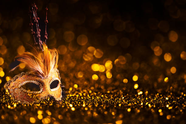 Luxury venetian mask on dark golden bokeh background. Luxury venetian mask on dark godlen bokeh background. New year and christmas party celebration design banner. Carnival masquerade fantasy costume ball. evening ball stock pictures, royalty-free photos & images