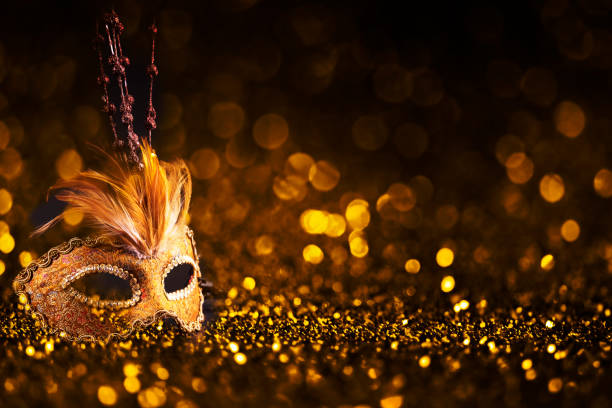 Luxury venetian mask on dark golden bokeh background. Luxury venetian mask on dark godlen bokeh background. New year and christmas party celebration design banner. Carnival masquerade fantasy costume ball. carnival costume stock pictures, royalty-free photos & images