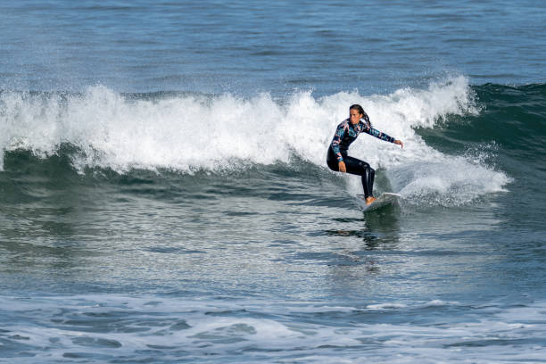 istock Surfer girl riding a wave 1425863565